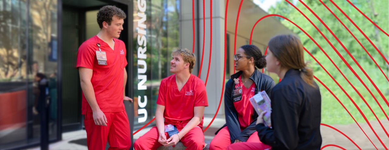 students interacting in front of procter hall