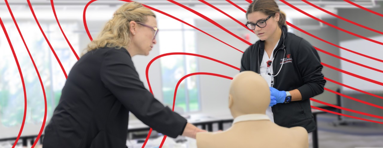 instructor and student practicing with manikin