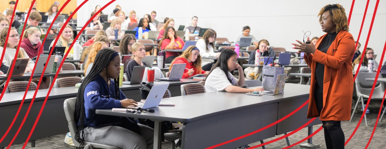 instructor in front of lecture hall