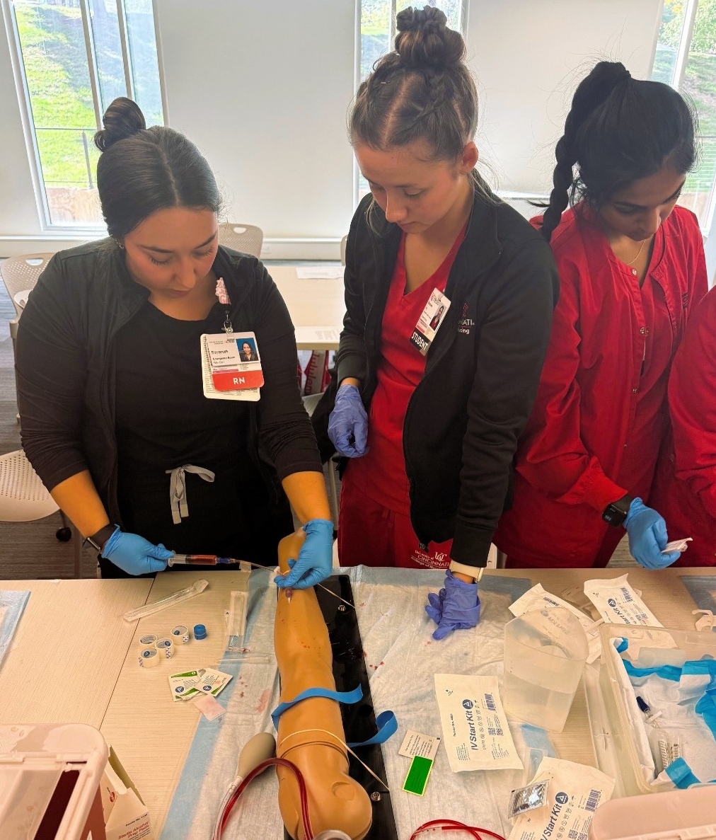 student and instructor practicing IV insertion